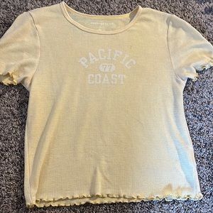 This is a cute yellow and white cropped shirt with no stains and only worn once.